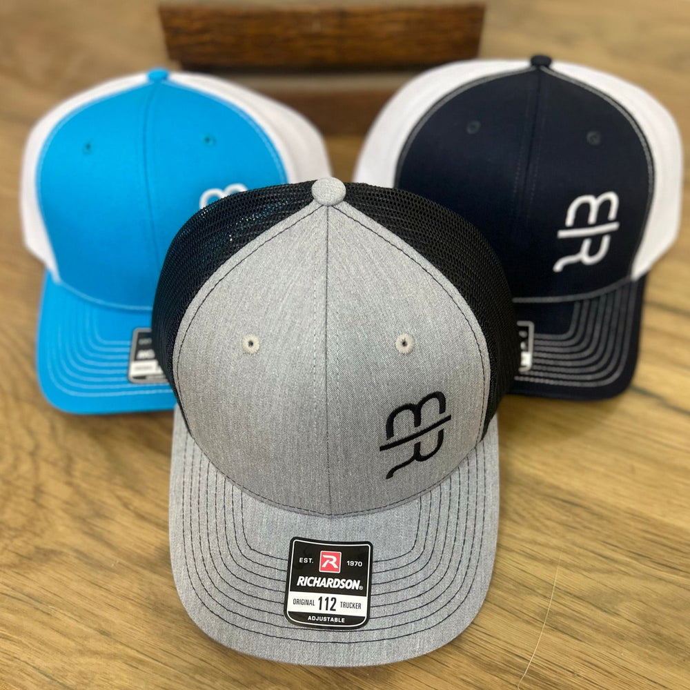 
                  
                    Light gray trucker hat with the black MR brand on the crown.  
                  
                