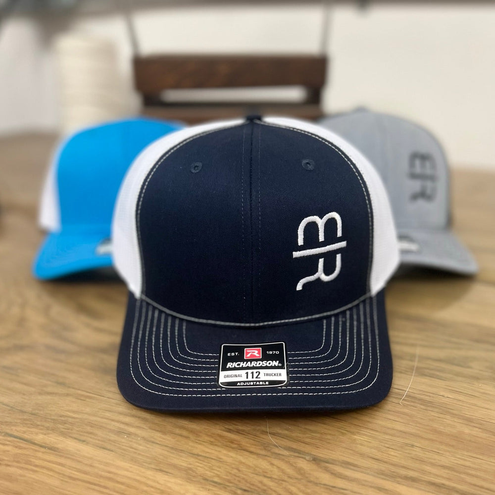 Navy blue trucker hat with white stitching and white MR brand on the crown.  